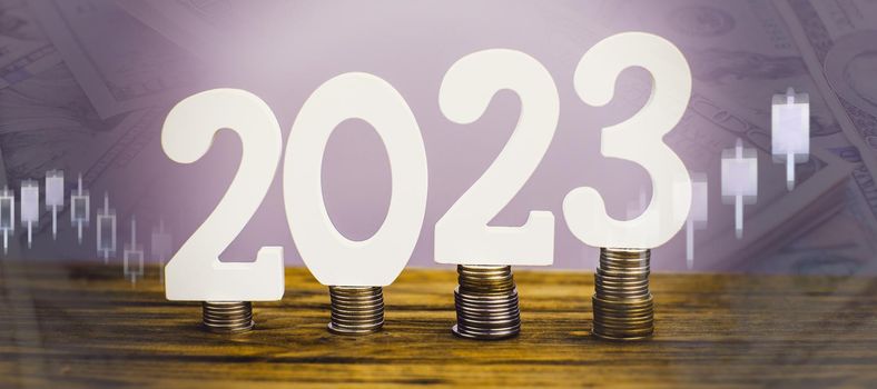 2023 on the stack of coins. tax payment, investment, and banking concept. 2023 new year saving money and financial planning concept