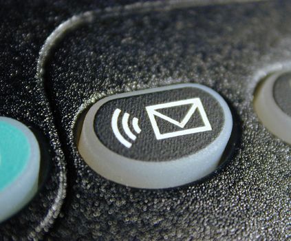 Voice mail sound alert button with envelope icon on a keypad in a close up view