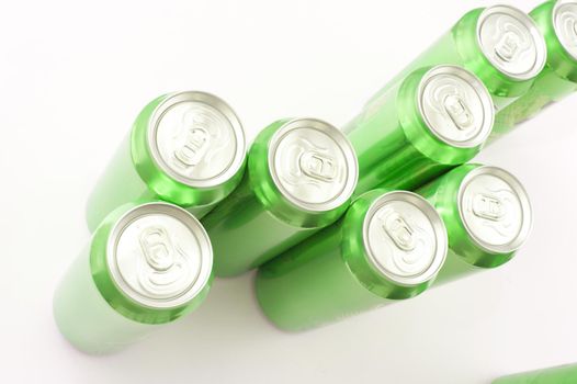 Group of green unopened aluminium soda or soft drink cans viewed from above on a white background