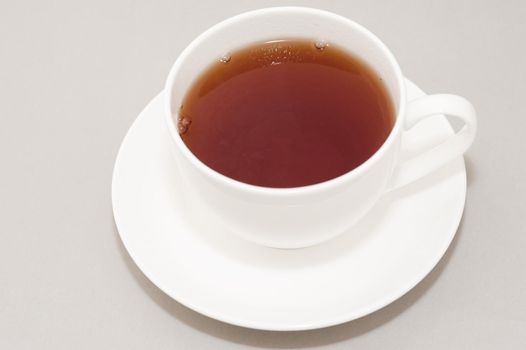 High Angle View of Hot Brewed Black Tea in Clean White Cup on Saucer in Studio with Neutral Gray Background