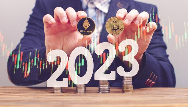 Businessman thinking about investing in cryptocurrency in 2023, choice between Ethereum and Bitcoin against the background of the chart