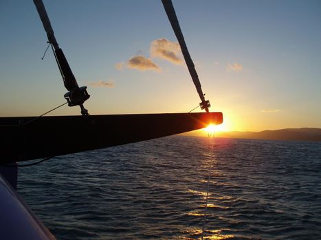 a relaxing way to travel, sailing on a yacht at sunset