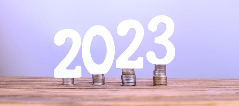 2023 on the stack of coins. tax payment, investment, and banking concept. 2023 new year saving money and financial planning concept