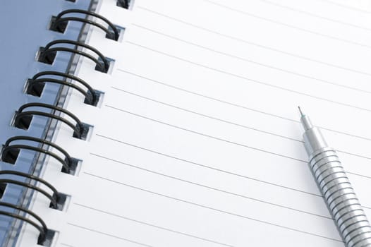 Open ringbound notebook with blank lined pages and a mechanical pencil ready for you to write your text or message