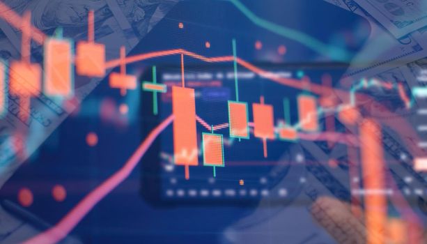 Charts of financial instruments with various type of indicators including volume analysis for professional technical analysis on the monitor of a computer.