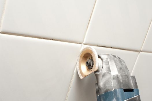 removing grout between bathroom towles with an oscillating type tool