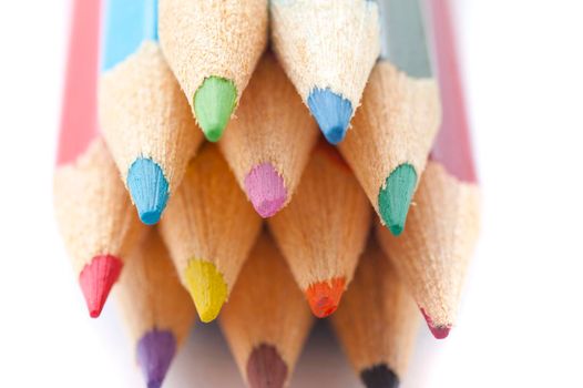 Artistic background of the colourful palette of pencil crayons with a close up view of the sharpened points facing the camera