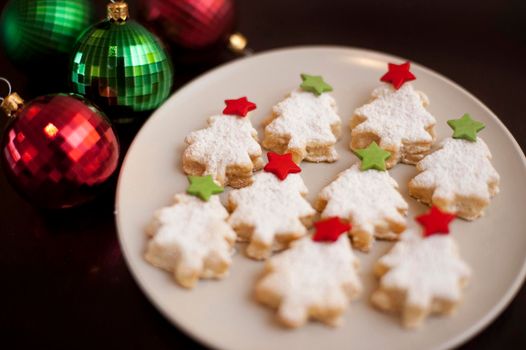 Tasty golden Christmas cookies in the shape of Christmas trees home baked to celebrate the festive Xmas holiday