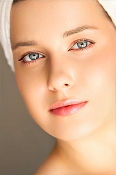 Skin care and beauty routine, beautiful woman with white towel wrapped around head, skincare cosmetics and face cosmetology, close-up portrait