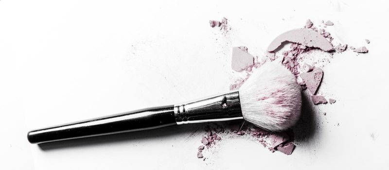 Beauty texture, cosmetic product and art of make-up concept - Brush with crushed eyeshadow and powder close-up isolated on white background