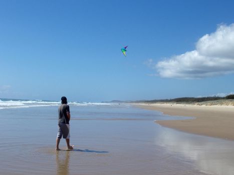 flying a kite on the beach