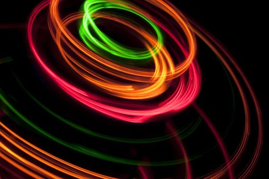 a round twisting pattern of brilliantly glowing coloured lines