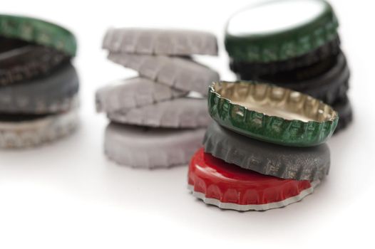 Still Life Close Up of Stacks of Colorful Bottle Caps on White Background with Copy Space