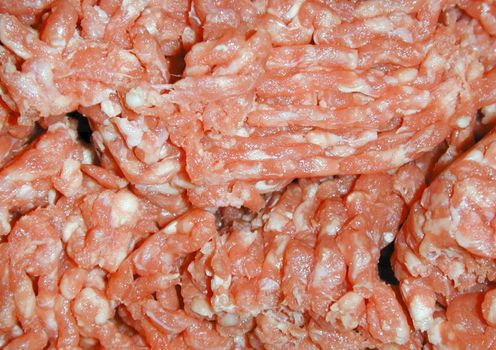 Background texture of raw uncooked mince meat with specks of fat ready for using as an ingredient in cooking