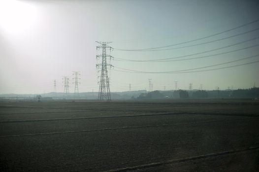 high voltage overhead powerlines with a high key sun flare effect