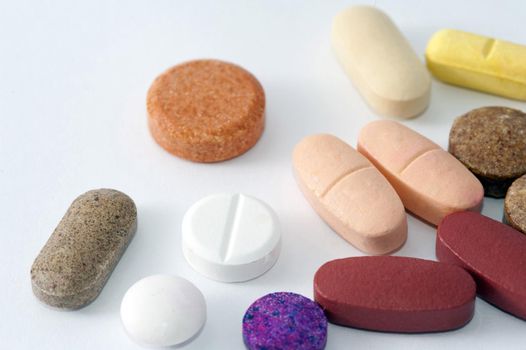 various shaps of pills on a white background