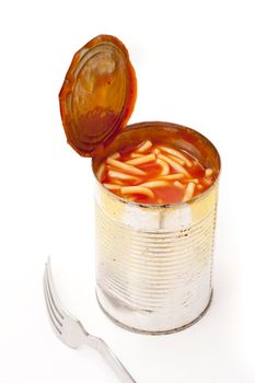 High angle view of an open tin of spaghetti or noodles in tomato sauce with a for alongside on a white background