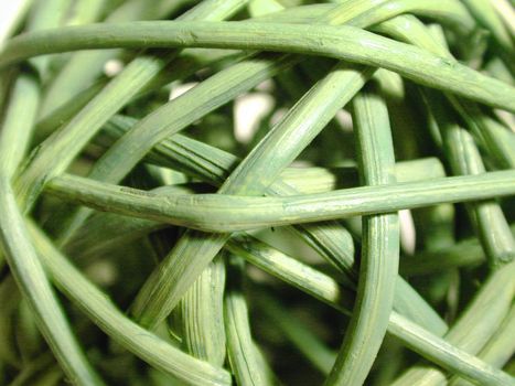 Background texture of random woven green rushes, close up full frame