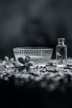 Raw fenugreek seeds on the wooden surface with some coconut oil and its paste in a glass bowl used as the remedy of dandruff.Famous natural method.