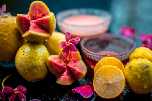 The easiest method to cure acne and scars with guava face mask consisting of guava pulp, honey, and some lemon juice. With ingredients on wooden surface in a glass bowl.;