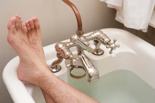 stretching out in a nice hot retro styled bath