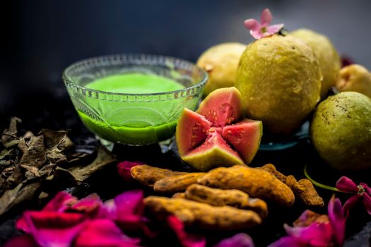 Guava, Neem or Indian lilac leaves, turmeric powder well mixed in a glass bowl for treatment of pimples and acne in the spa by beauticians.