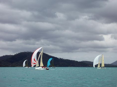 four yachts racing on a stormy looking day