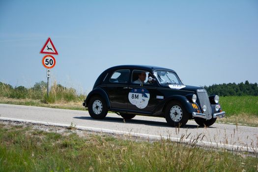 URBINO - ITALY - JUN 16 - 2022 : LANCIA ARDESIA 1952 on an old racing car in rally Mille Miglia 2022 the famous italian historical race (1927-1957