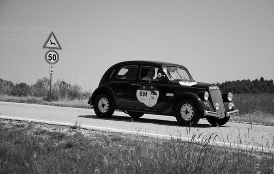 URBINO - ITALY - JUN 16 - 2022 : LANCIA ARDESIA 1952 on an old racing car in rally Mille Miglia 2022 the famous italian historical race (1927-1957