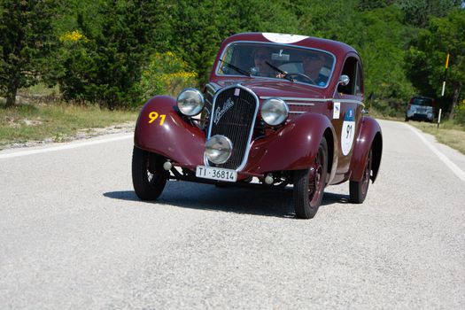 URBINO - ITALY - JUN 16 - 2022 : FIAT 508 S MM BALILLA BERLINETTA AERODINAMICA 1935 on an old racing car in rally Mille Miglia 2022 the famous italian historical race (1927-1957