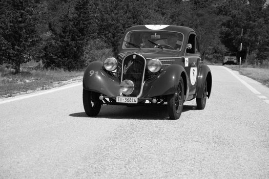 URBINO - ITALY - JUN 16 - 2022 : FIAT 508 S MM BALILLA BERLINETTA AERODINAMICA 1935 on an old racing car in rally Mille Miglia 2022 the famous italian historical race (1927-1957