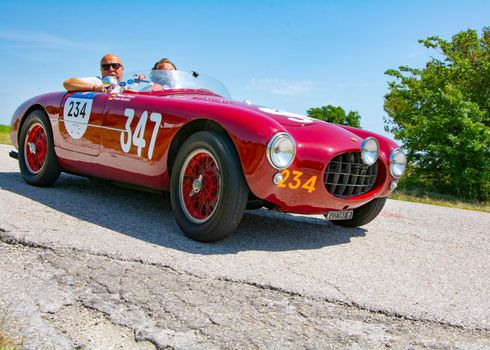 URBINO - ITALY - JUN 16 - 2022 : FIAT 500 C BELVEDERE 1952 on an old racing car in rally Mille Miglia 2022 the famous italian historical race (1927-1957