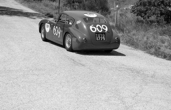 URBINO - ITALY - JUN 16 - 2022 : ERMINI 1100 BERLINETTA MOTTO 1950 on an old racing car in rally Mille Miglia 2022 the famous italian historical race (1927-1957