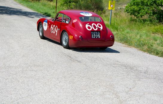 URBINO - ITALY - JUN 16 - 2022 : ERMINI 1100 BERLINETTA MOTTO 1950 on an old racing car in rally Mille Miglia 2022 the famous italian historical race (1927-1957