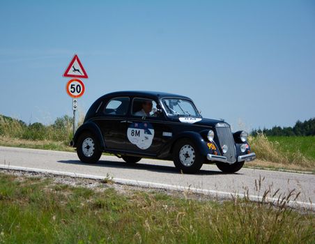 URBINO - ITALY - JUN 16 - 2022 : LANCIA ARDESIA 1952 on an old racing car in rally Mille Miglia 2022 the famous italian historical race (1927-1957