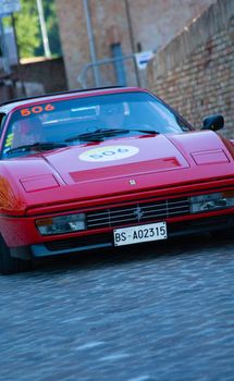 URBINO - ITALY - JUN 16 - 2022 : FERRARI 328 GTS on an old racing car in rally Mille Miglia 2022 the famous italian historical race (1927-1957