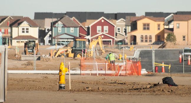 Construction site with houses on background.