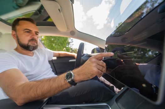 Caucasian man driving a modern electric car