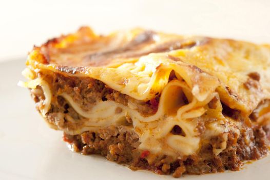 Close up Appetizing Homemade Lasagne Food on White Plate with White Background.