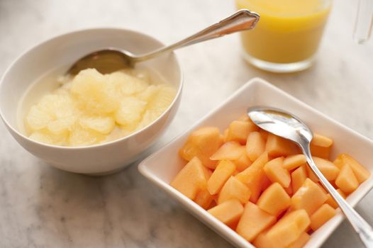 Summer breakfast: chopped papaya and pineapple in bowls