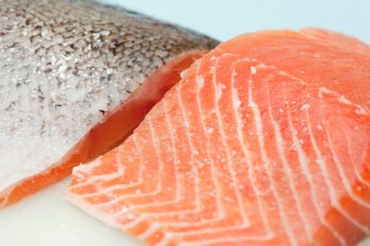 Fresh salmon steak textures with two fillets, one with the succulent flesh uppermost and the second showing the skin