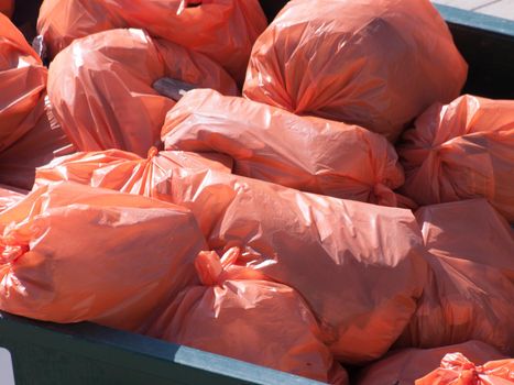 Pile of orange garbage bags.