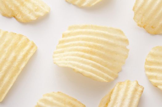 Close up on centered curved ridged potato chip for background about snack or junk food