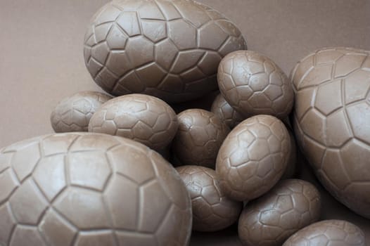 Chocolate treat of a collection of different sized unwrapped milk chocolate eggs