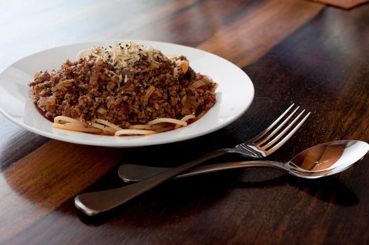 Serving of spaghetti Bolognese or Bolognaise topped with minced beef cooked in a tomato base