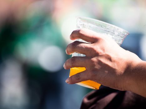 Hand holding glass with beer.