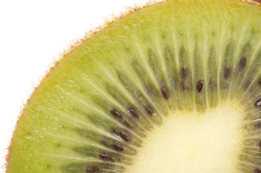 Macro detail of a cut fresh kiwifruit showing the succulent green flesh and rayed pattern of the pips isolated on white