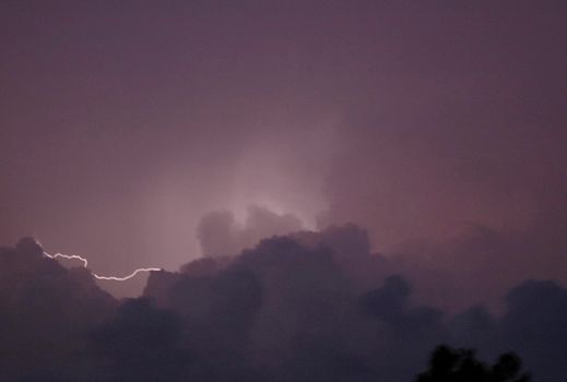 lighting flash between clouds in a thunderstorm - blurred image