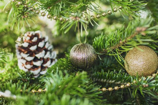 Gold decoration toys and cone on the Christmas tree