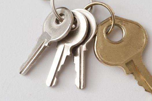 Security Concept - Close up Luggage Keys on a Ring , on Off White Background.